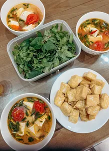Bowls of Hanoi’s tofu soup with tomato and greens plus a plate of fried tofu at Bamboo Life’s make-tofu workshop