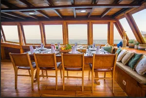 Breakfast dining set in a luxury phinisi lounge with sea views on a 3D2N private Komodo liveaboard in Labuan Bajo