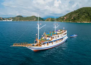 Traditional phinisi sailboat cruising in open water during a 3-day join-in Komodo boat trip in Labuan Bajo