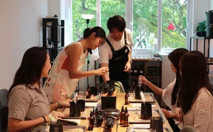 Guests pouring wax during WICKKA STUDIO crystal candle making & manifestation candle workshop in Singapore, guided by the host