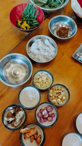 Bowls of fresh vegetables, spices and garlic laid out for Traditional Manggarai vegan cooking at The Kitchen Garden Bajo, Labuan Bajo
