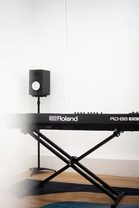 Roland keyboard and studio speaker in SmallGiant Music rehearsal space in Singapore for composing soundtracks during workshops in Singapore