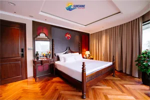 Sunshine Golden Cruises cabin interior with a neatly made bed, antique-style wooden dresser, mirrors and soft bedside lamps
