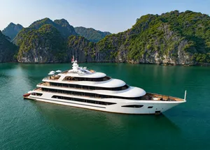 White Oasis Bay Party Cruiser sailing through Halong Bay with limestone karsts rising from turquoise water