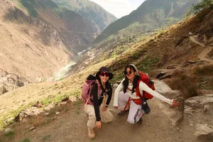 Backpackers hiking along a dirt trail with wide valley views in Tiger Leaping Gorge, Lijiang, on the 2D1N high trail