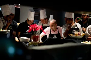 Chefs plate ingredients in Singapore during the team local produce cooking challenge, saucepans and bowls ready — workshops in Singapore
