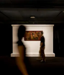 Visitors view framed paintings on an expert-led Vietnamese art tour at Quang San Art Museum in Ho Chi Minh City