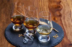 Amber whisky in clear tumblers on a slate coaster at a hidden home bar, private dining Singapore with Scotch & Sambal