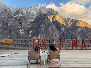 Travellers seated at a mountain viewpoint over steep peaks on the 2D1N Lesser-Known High Trail of Tiger Leaping Gorge, Lijiang