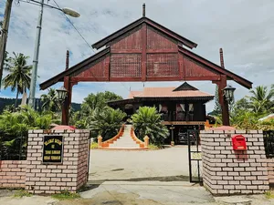 Red-roofed building entrance and gate in Langkawi, a landmark start along the villages, markets and jetty cycling route