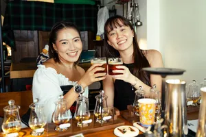 Guests clink small-batch whisky glasses at Scotch & Sambal’s hidden home bar in Singapore for private dining Singapore